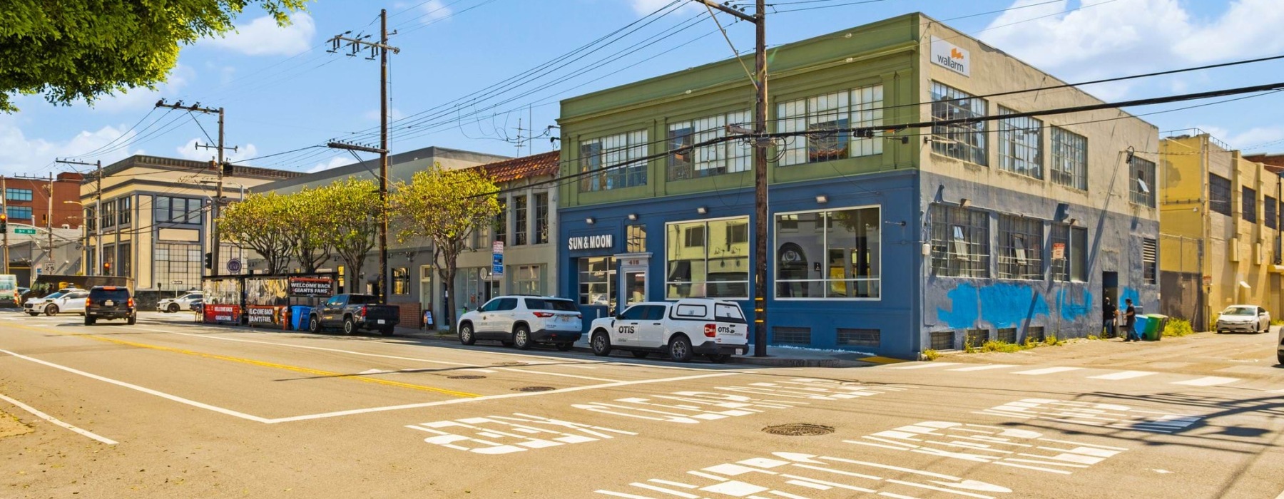 street corner with blue and green buildings