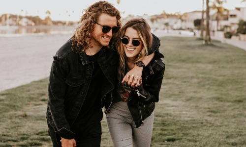 a couple smiling and walking