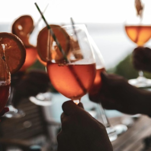people holding drinks with fruit