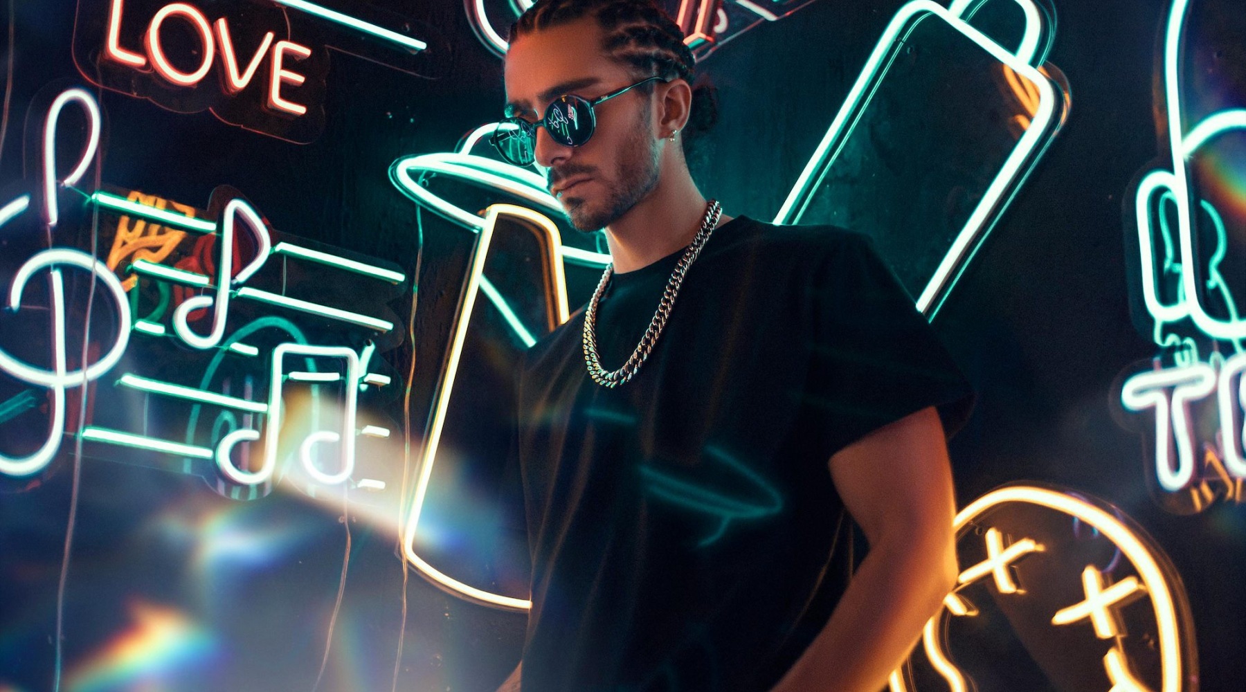 a person standing in front of many neon lights