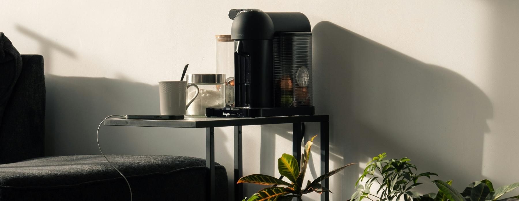a table with plants and a painting on the wall